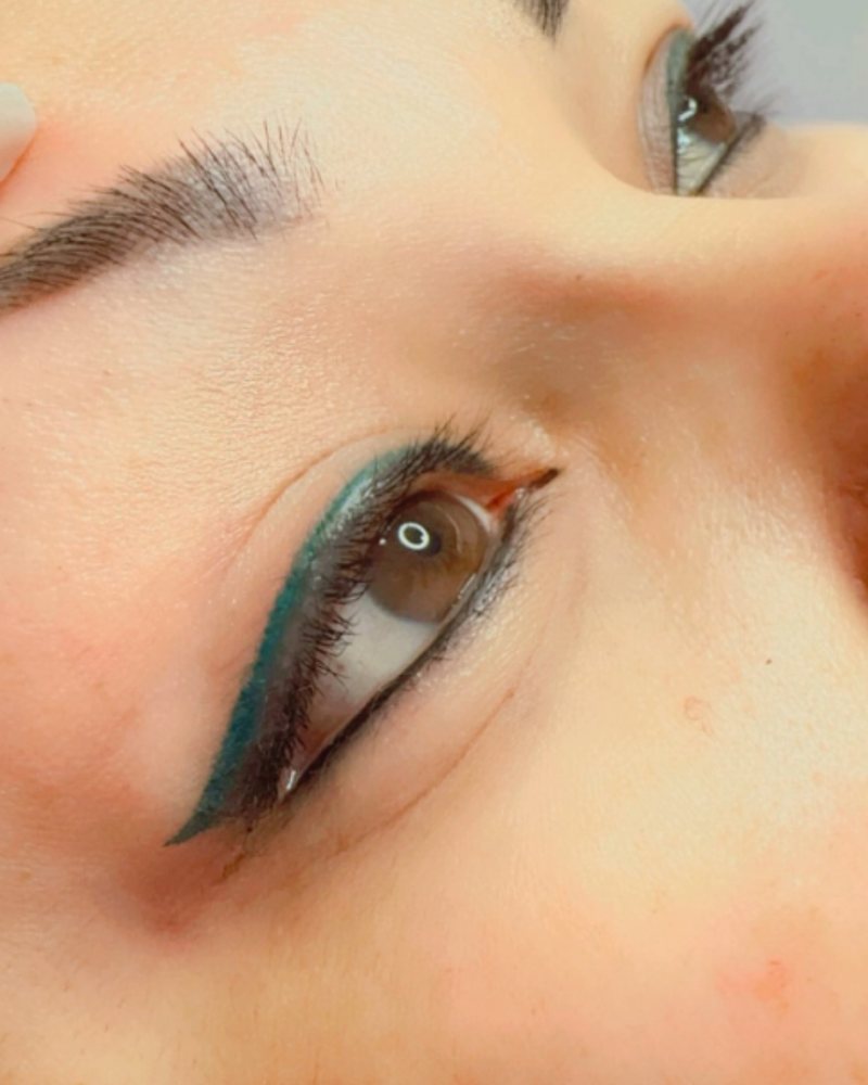 Teal permanent eyeliner with a small wing
